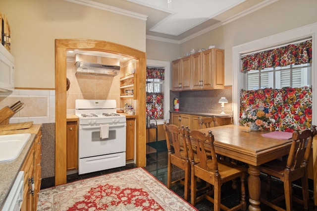 kitchen with decorative backsplash, light brown cabinets, white appliances, and ornamental molding