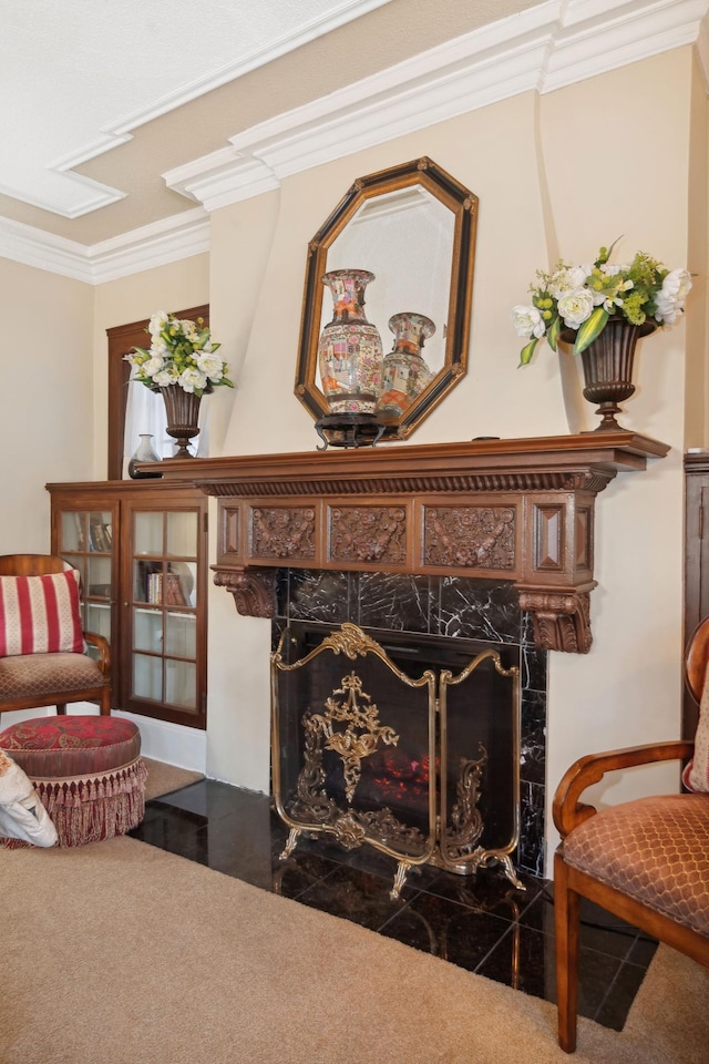 sitting room featuring carpet, crown molding, and a high end fireplace