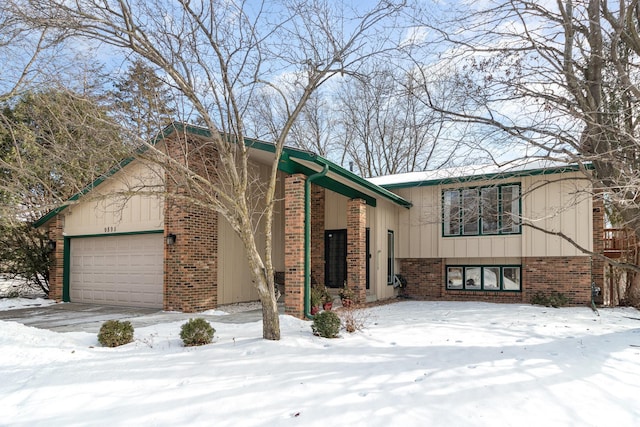 view of front facade with a garage and brick siding