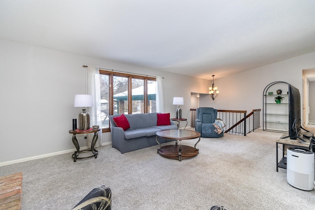 living room featuring lofted ceiling, baseboards, carpet flooring, and a notable chandelier