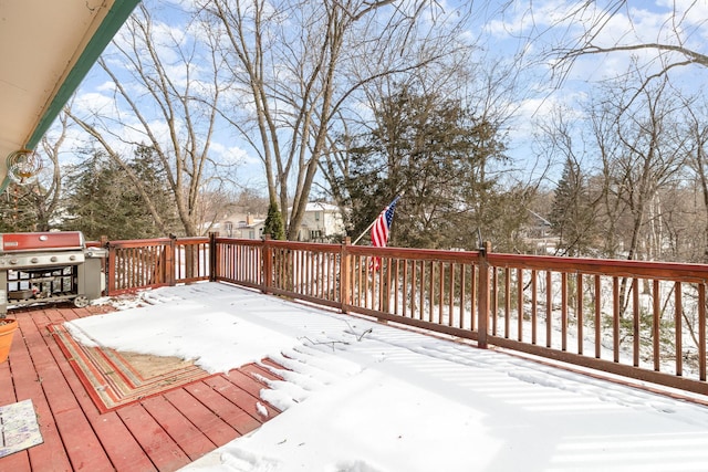 snow covered deck featuring a grill