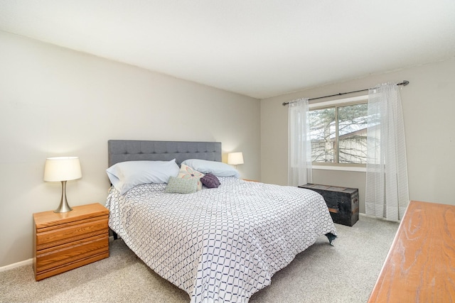 bedroom with carpet floors and baseboards