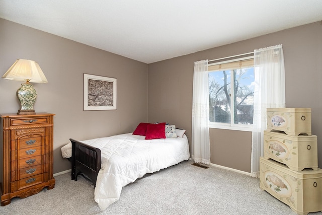 carpeted bedroom featuring visible vents and baseboards