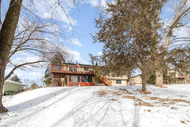 view of front facade with stairway and a wooden deck