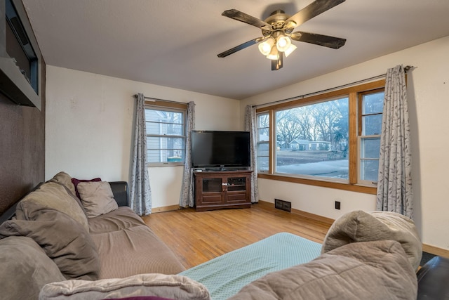 living room with ceiling fan and light hardwood / wood-style floors