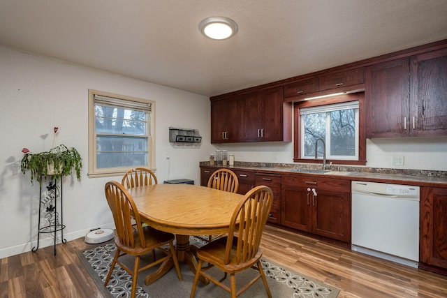 dining room featuring hardwood / wood-style floors, a healthy amount of sunlight, and sink