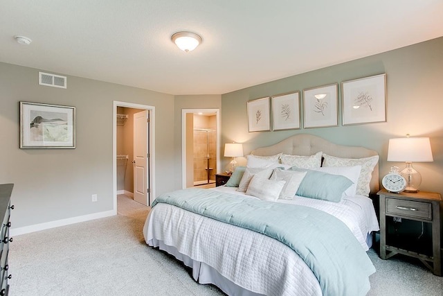 carpeted bedroom with connected bathroom, a spacious closet, and a closet