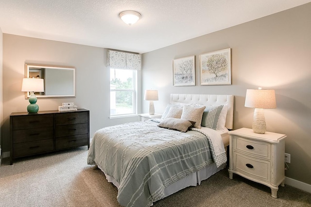 bedroom featuring carpet flooring and a textured ceiling