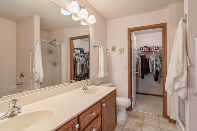 bathroom with vanity, plus walk in shower, and a textured ceiling