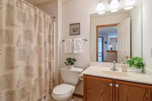 bathroom with a shower with curtain, vanity, and toilet