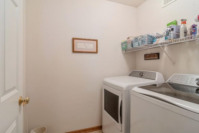 clothes washing area with separate washer and dryer