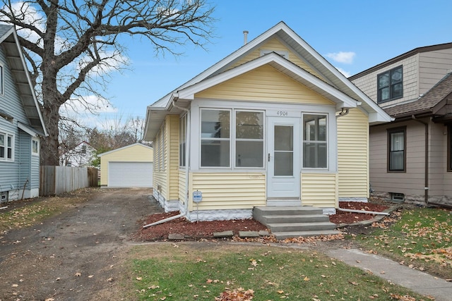 bungalow-style home featuring an outbuilding and a garage