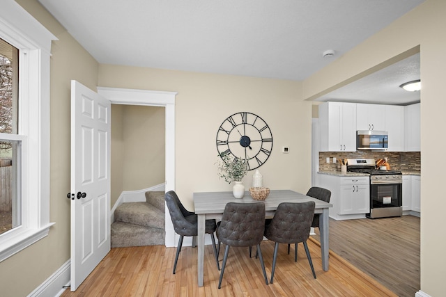 dining space featuring light wood-type flooring