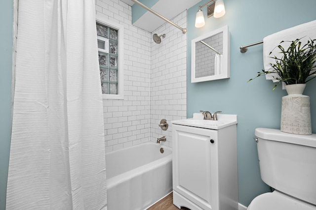 full bathroom with vanity, shower / bath combo, and toilet