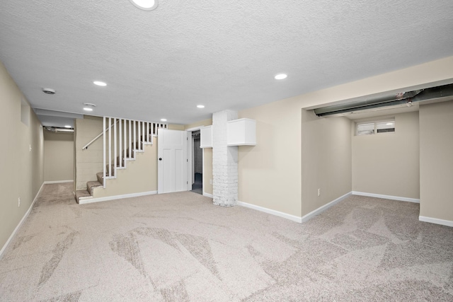 basement with light colored carpet and a textured ceiling