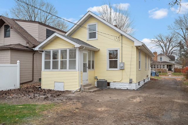 rear view of property with cooling unit