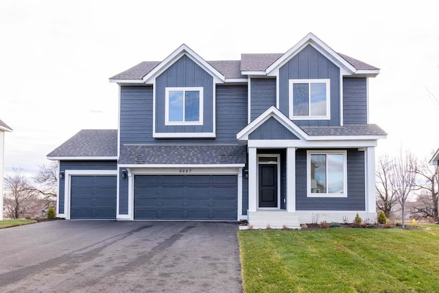 view of front of house with a front yard and a garage