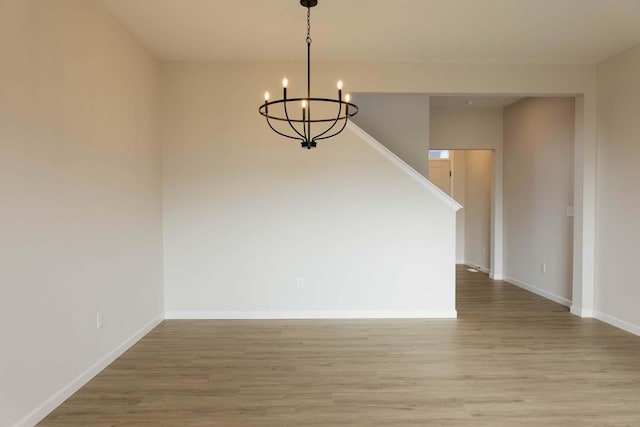 interior space featuring hardwood / wood-style floors and an inviting chandelier