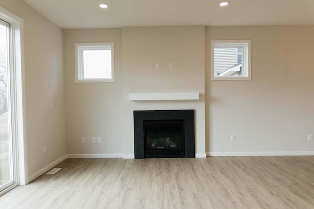 unfurnished living room featuring light wood-type flooring