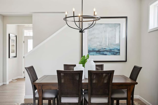 dining space featuring a chandelier and wood-type flooring