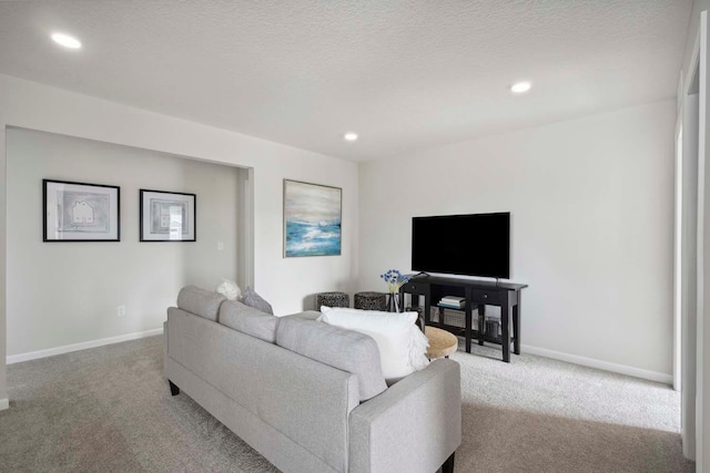 living room featuring light colored carpet and a textured ceiling