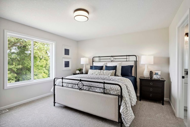 carpeted bedroom featuring a textured ceiling