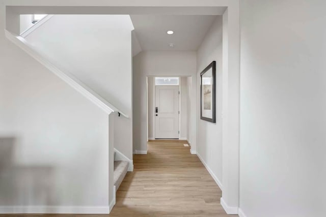 hall with stairway, baseboards, light wood-style floors, and recessed lighting