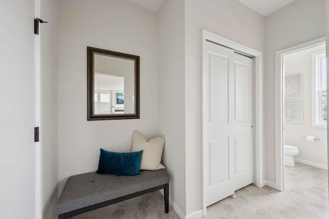 living area featuring baseboards
