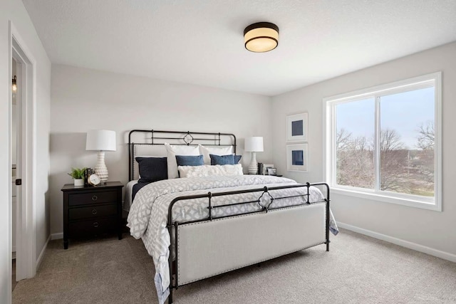 bedroom with baseboards and carpet