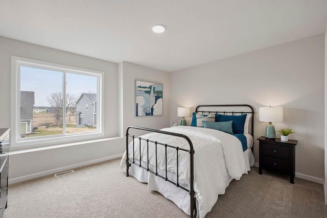 bedroom featuring carpet flooring, baseboards, and visible vents