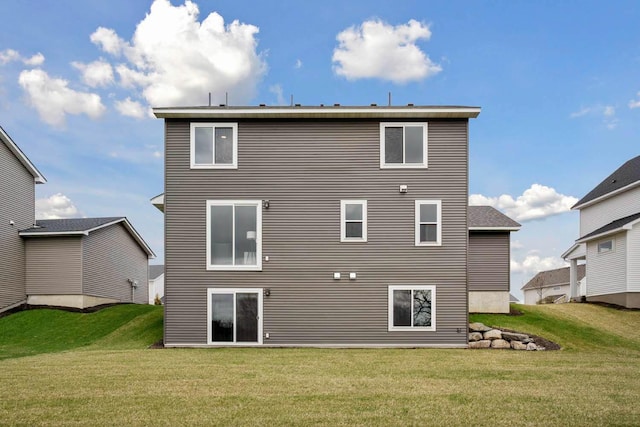 back of house with a lawn