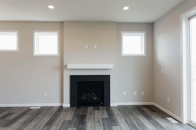 unfurnished living room with dark hardwood / wood-style floors