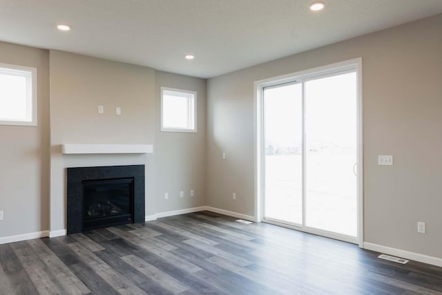 unfurnished living room featuring dark hardwood / wood-style floors