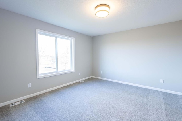 spare room featuring carpet flooring