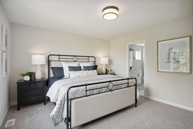 carpeted bedroom featuring ensuite bathroom