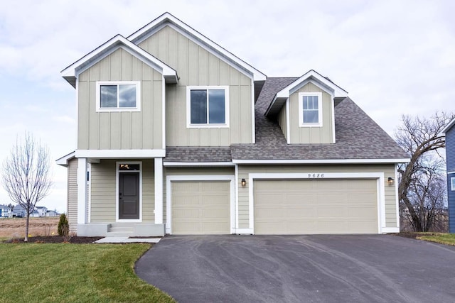 view of front of property with a garage and a front lawn