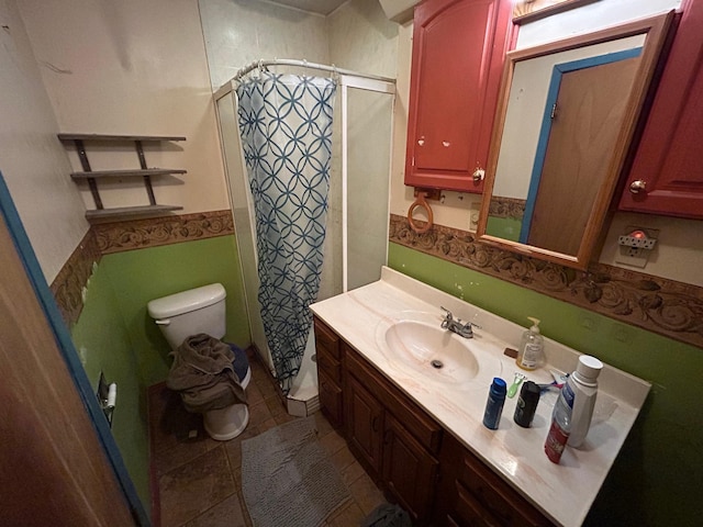 bathroom featuring tile patterned flooring, vanity, toilet, and curtained shower