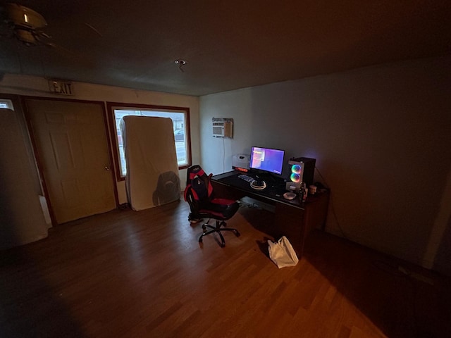 home office with hardwood / wood-style floors and a wall unit AC