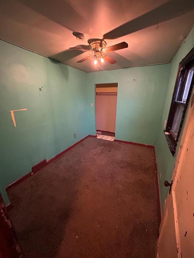 unfurnished bedroom with carpet, ceiling fan, and a closet