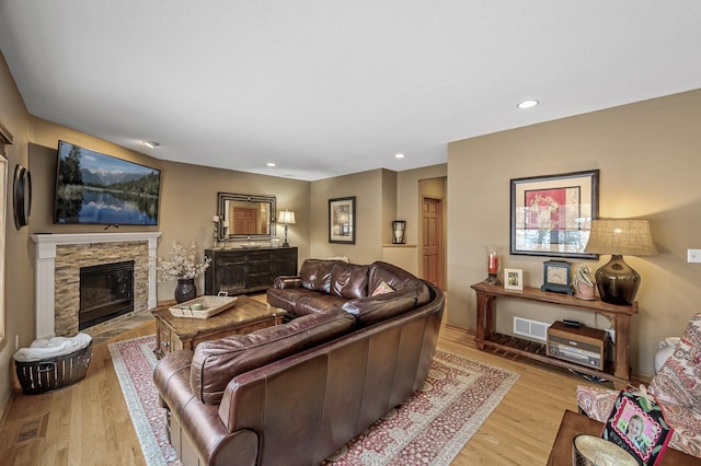 2567 Bridle Creek Trl, Chanhassen, MN 55317 - living area featuring light wood finished floors, recessed lighting, and a stone fireplace