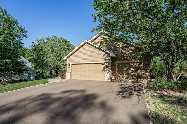 2567 Bridle Creek Trl, Chanhassen, MN 55317 - view of front of property featuring driveway, an attached garage, and brick siding