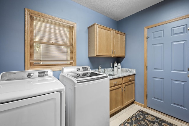 2567 Bridle Creek Trl, Chanhassen, MN 55317 - laundry room with independent washer and dryer, cabinet space, light tile patterned floors, and a textured ceiling