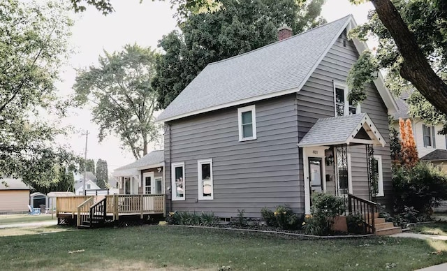 view of front facade with a front yard and a deck