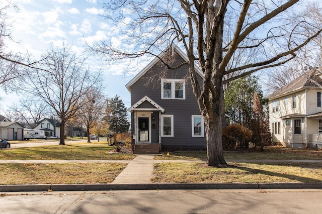 view of property featuring a front lawn