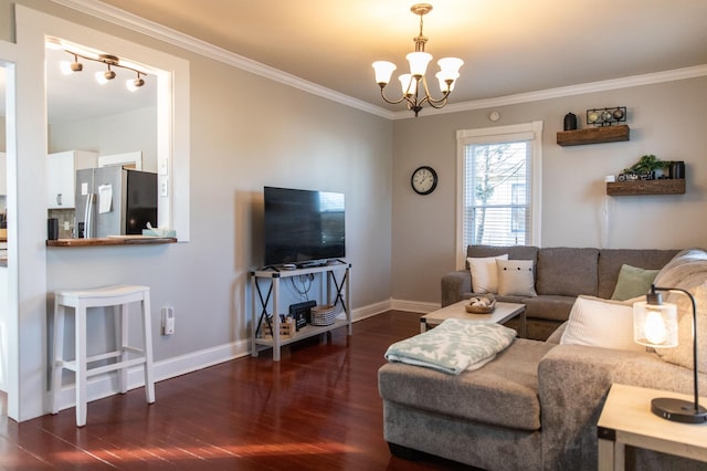 living room featuring a chandelier, dark hardwood / wood-style floors, and ornamental molding