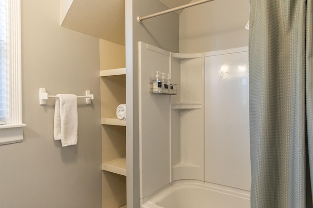 bathroom with shower / bath combo and a textured ceiling