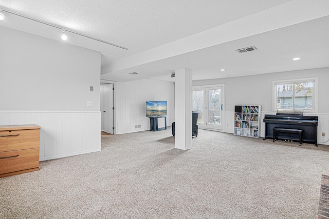 living room with plenty of natural light and light colored carpet