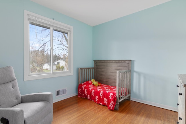 bedroom with hardwood / wood-style floors