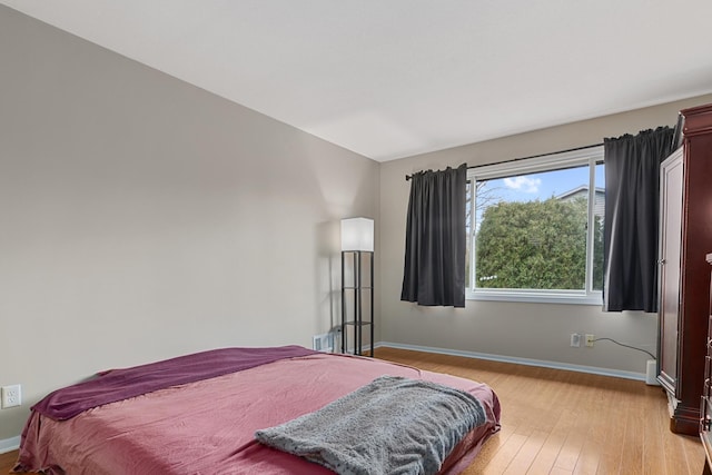 bedroom with light wood-type flooring