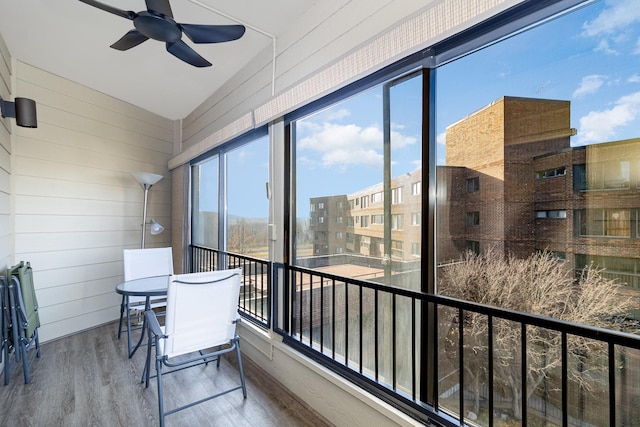 sunroom / solarium featuring ceiling fan